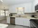 Well-maintained kitchen featuring sleek stainless steel appliances and bright white cabinetry at 3313 Ventura Cir, Wake Forest, NC 27587