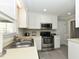 Well-maintained kitchen featuring sleek stainless steel appliances and bright white cabinetry at 3313 Ventura Cir, Wake Forest, NC 27587