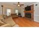 Spacious living room features hardwood floors, a brick fireplace, and ample natural light at 3313 Ventura Cir, Wake Forest, NC 27587