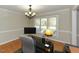 Well-lit office featuring hardwood floors, a modern desk, and a large window at 3313 Ventura Cir, Wake Forest, NC 27587