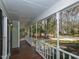 Inviting covered porch with wood flooring and white railings, perfect for relaxing outdoors at 3313 Ventura Cir, Wake Forest, NC 27587