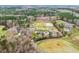 Extensive aerial view of estate with paddocks, home, barns, and pond at 3417 Pea Ridge Rd, New Hill, NC 27562