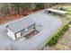 Aerial view of gray garage near the house, ample gravel, and a garden at 3417 Pea Ridge Rd, New Hill, NC 27562