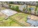 Expansive aerial view of equestrian estate, showcasing horse paddocks, riding ring, pastures, and barn with surrounding wooded areas at 3417 Pea Ridge Rd, New Hill, NC 27562