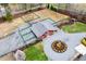 Aerial view of a barn with paddocks and green spaces, including a circular landscaped feature at 3417 Pea Ridge Rd, New Hill, NC 27562