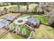 Aerial view of estate featuring a red barn, house, and circular driveway at 3417 Pea Ridge Rd, New Hill, NC 27562
