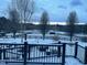 Snowy backyard and fencing can be seen from the cozy covered deck at 3417 Pea Ridge Rd, New Hill, NC 27562