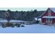 Snowy property featuring a red barn and surrounding fence line at 3417 Pea Ridge Rd, New Hill, NC 27562