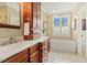 Elegant bathroom featuring a double vanity and soaking tub at 3417 Pea Ridge Rd, New Hill, NC 27562