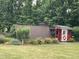 Backyard featuring a chicken coop with an attached run surrounded by lush greenery at 3417 Pea Ridge Rd, New Hill, NC 27562