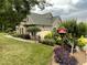 Charming home exterior with stone accents, well-maintained landscaping, and a birdhouse at 3417 Pea Ridge Rd, New Hill, NC 27562