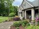 Exterior view of a stone-accented home with manicured landscaping and a brick walkway at 3417 Pea Ridge Rd, New Hill, NC 27562