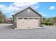 Exterior view of gray building with a beige garage door and decorative sun at 3417 Pea Ridge Rd, New Hill, NC 27562
