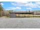Run-in shed with a wooded backdrop and gravel in front at 3417 Pea Ridge Rd, New Hill, NC 27562