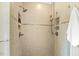 Modern walk-in shower featuring dual shower heads and tiled walls at 3417 Pea Ridge Rd, New Hill, NC 27562