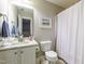 Neutral bathroom featuring white cabinetry, marble countertops, and shower with white curtain at 345 Anterbury Dr, Apex, NC 27502