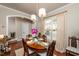 Charming dining room featuring hardwood floors, an oval table with seating for six, and bright, natural lighting at 345 Anterbury Dr, Apex, NC 27502
