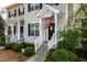 Inviting home entrance adorned with lush landscaping, a decorative door, and a welcoming staircase at 345 Anterbury Dr, Apex, NC 27502