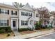 Attractive townhome showcasing a neat front garden, sidewalk, and pleasing architectural details at 345 Anterbury Dr, Apex, NC 27502