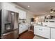 Bright kitchen with stainless steel refrigerator and a convenient view of the cozy living area at 345 Anterbury Dr, Apex, NC 27502