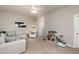Open living area with comfy sectional, ceiling fan and a corner chair at 345 Anterbury Dr, Apex, NC 27502