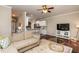 Open living room with modern furniture flowing into the breakfast bar with seating and an open kitchen at 345 Anterbury Dr, Apex, NC 27502