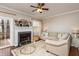 Comfortable living room featuring a fireplace, neutral sofa, and a glass coffee table at 345 Anterbury Dr, Apex, NC 27502
