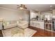 Open living room showing a comfortable couch, a coffee table, and barstool seating at the kitchen counter at 345 Anterbury Dr, Apex, NC 27502