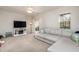 Open-concept living room with modern sectional sofa and entertainment center at 345 Anterbury Dr, Apex, NC 27502
