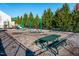 Community playground with swings, slides, and a picnic table, perfect for outdoor Gathering fun and recreation at 345 Anterbury Dr, Apex, NC 27502