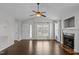 Inviting living room showcases a fireplace, large windows for natural light, and smooth hardwood flooring at 35 Flume Rd, Franklinton, NC 27525