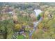 Overhead shot of homes surrounded by mature trees, close to the serene lake and a quiet neighborhood at 4117 Olde Coach Rd, Durham, NC 27707