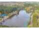 Scenic aerial view of a pond surrounded by lush, mature trees at 4117 Olde Coach Rd, Durham, NC 27707