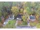 Aerial view of multiple homes with green lawns and mature trees at 4117 Olde Coach Rd, Durham, NC 27707