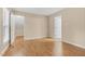 Bedroom with hardwood floors and two doorways for easy access to other rooms at 4117 Olde Coach Rd, Durham, NC 27707