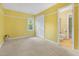 Bright bedroom with yellow walls and a window providing natural light at 4117 Olde Coach Rd, Durham, NC 27707