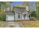 Charming home featuring a well-manicured lawn, a garage, and welcoming front porch at 4117 Olde Coach Rd, Durham, NC 27707