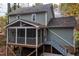 View of the exterior of a muted green home with a screened in back porch at 4117 Olde Coach Rd, Durham, NC 27707