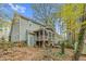 Exterior of house with screened porch overlooking wooded backyard at 4117 Olde Coach Rd, Durham, NC 27707
