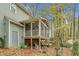 Exterior view featuring the home's porch, wooded lot and backyard at 4117 Olde Coach Rd, Durham, NC 27707