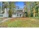 Front exterior of a one-story home with a green lawn, driveway, and mature trees at 4117 Olde Coach Rd, Durham, NC 27707