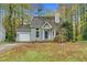 Front exterior of a one-story home with a green lawn, driveway, and mature trees at 4117 Olde Coach Rd, Durham, NC 27707
