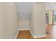 Hallway featuring hardwood floors, a storage closet, and access to other rooms at 4117 Olde Coach Rd, Durham, NC 27707