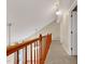 Hallway featuring carpet floors, wood railing, and views of the lower level at 4117 Olde Coach Rd, Durham, NC 27707