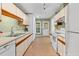 Galley style kitchen with neutral countertops, tile floors and ample cabinet storage at 4117 Olde Coach Rd, Durham, NC 27707