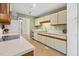 Galley kitchen featuring a range and views to the dining area at 4117 Olde Coach Rd, Durham, NC 27707