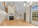 Spacious living room with vaulted ceilings, fireplace, large windows, and hardwood floors at 4117 Olde Coach Rd, Durham, NC 27707
