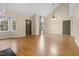 Bright living room with wood floors, vaulted ceiling, chandelier, and multiple entry doors at 4117 Olde Coach Rd, Durham, NC 27707