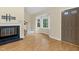 Inviting living room with fireplace, bay windows, wood floors, and natural light at 4117 Olde Coach Rd, Durham, NC 27707