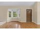 Bright and cozy living area with large bay window, hardwood floors, and natural light at 4117 Olde Coach Rd, Durham, NC 27707